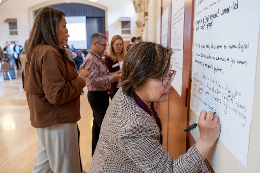 Person writing on a white board