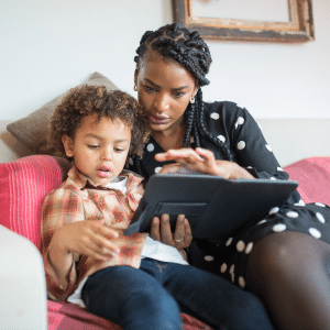 Parent and child using a tablet together at home